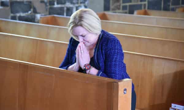 Judith Collins prays inside St Thomas Tamaki church before voting in Auckland.