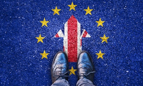 Feet on an asphalt road with parts of the UK and EU flags embedded in it