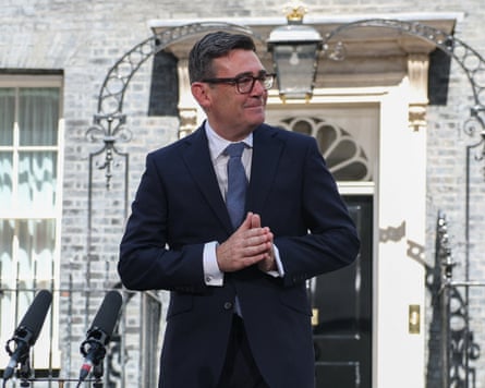 Andy Burnham stands next to microphones outside No 10