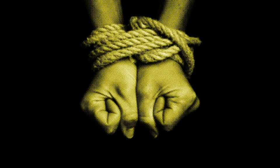 a pair of hands tied together with rope