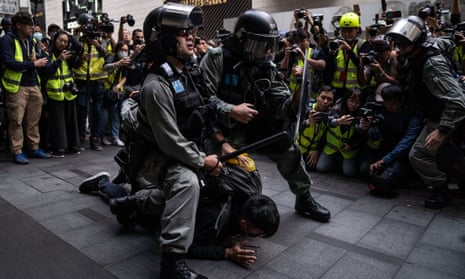 Hong Kong riot police detain a protester outside Chater Gardens during an anti-communism demonstration in January