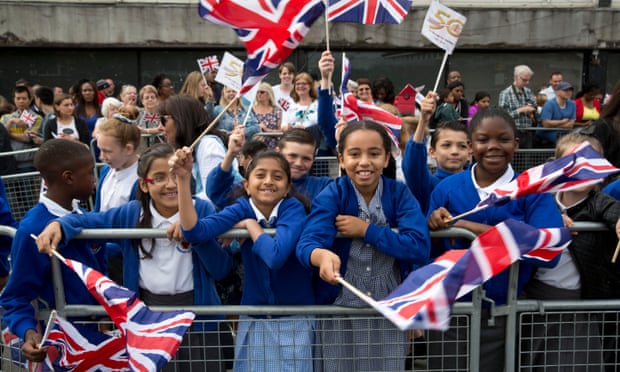 Children waving union flags during a visit of the Queen and Duke of Edinburgh to Chadwell Heath, east London, in 2015.