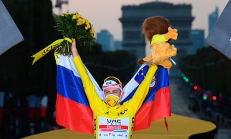 Tadej Pogacar celebrates on the podium.