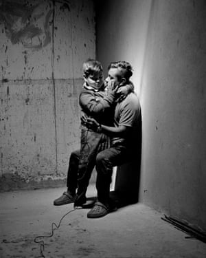 Carlos Soyos, 34,a migrant from Guatemala City, Guatemala and his son, Enderson Soyos, 8, take a self portrait at El Buen Samaritano migrant shelter, Juarez, Chihuahua, Mexico. The life of a migrant at the Mexico–United States border waiting for the right moment to cross into the US is often in flux.