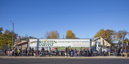 A long line outside of a food pantry where a Forgotten Harvest truck is parked