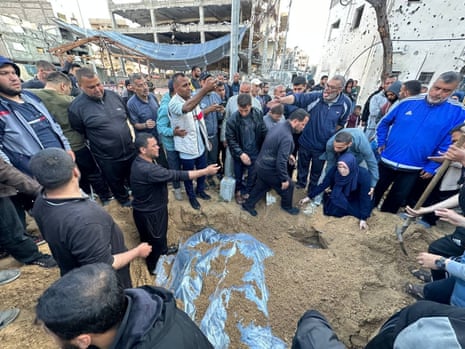 A crowd of mourners gather around as a funeral is held for three sons of Hamas leader Ismail Haniyeh, along with of his two grandchildren, in Gaza City. 