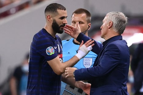 France’s coach Didier Deschamps (R) greets Karim Benzema after his substitution.