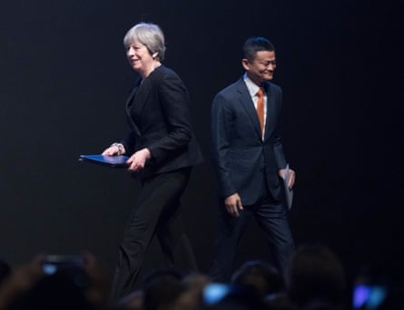 Theresa May passes Jack Ma, chairman of Alibaba Group Holding Ltd. as she walks on stage to speak at the China-Britain Business Forum