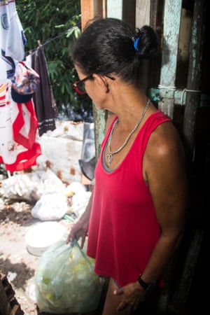 Maria das Gracas with bags of plastic waste she has collected from the Tejipió river