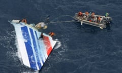 Dinghy approaches plane rudder in ocean