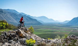Cyclist on the Ciro trail, Balkans, looking over valley