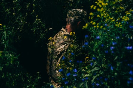 ‘Moments of beauty, of joy, of silence’ … near the front line amid yellow and blue flowers.