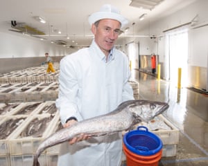 Jeremy Hunt holds a fish at the fish market during a visit to Peterhead in Aberdeenshire