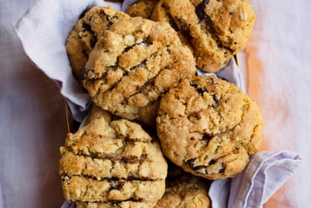 A batch of chocolate oat cookies on a light-purple linen napkin.