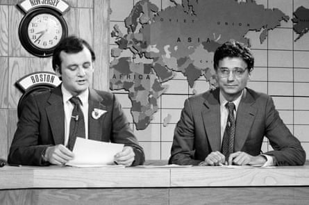 Two men sit at a desk
