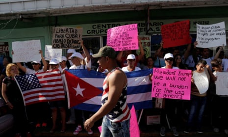 Cuban migrants stuck in Nuevo Laredo hold Cuban and American flags during a protest to ask the Mexican and the US governments to allow them to cross the border legally.