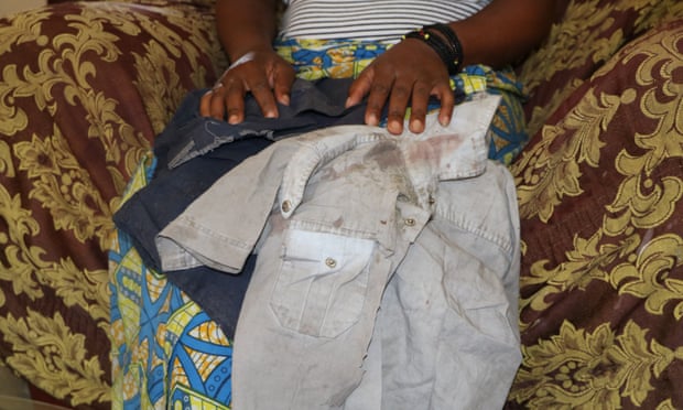 Ndoola holds the bloodstained shirt her eight-year-old son was wearing when he was kidnapped. Six days after the abduction he was released in a critical condition.