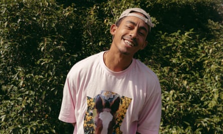 Jordan Stephens in Greenwich Park, smiling and leaning to one side