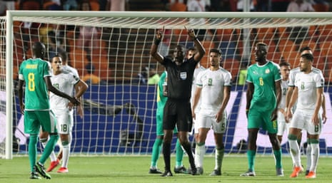 Referee Neant Alioum refers to VAR after awarding a penalty to Senegal.