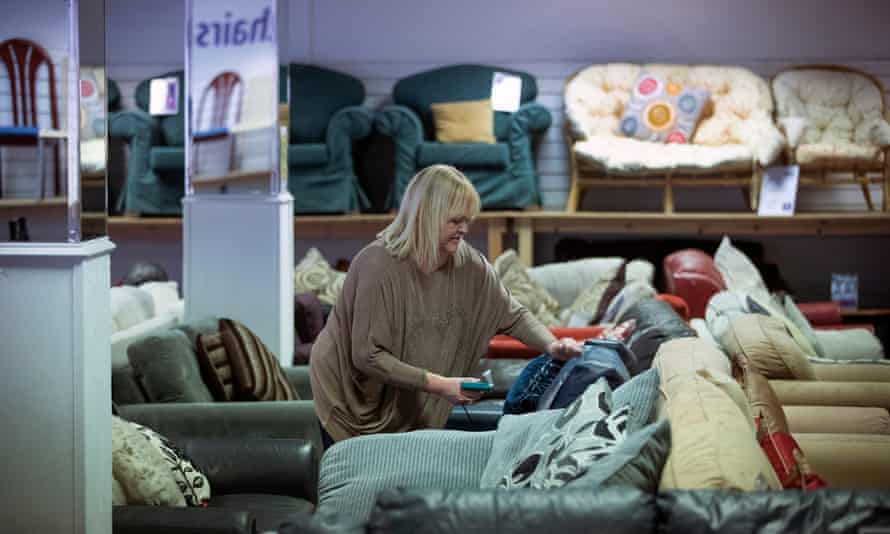 A staff member working on a sofa in a Bulky Bob's showroom