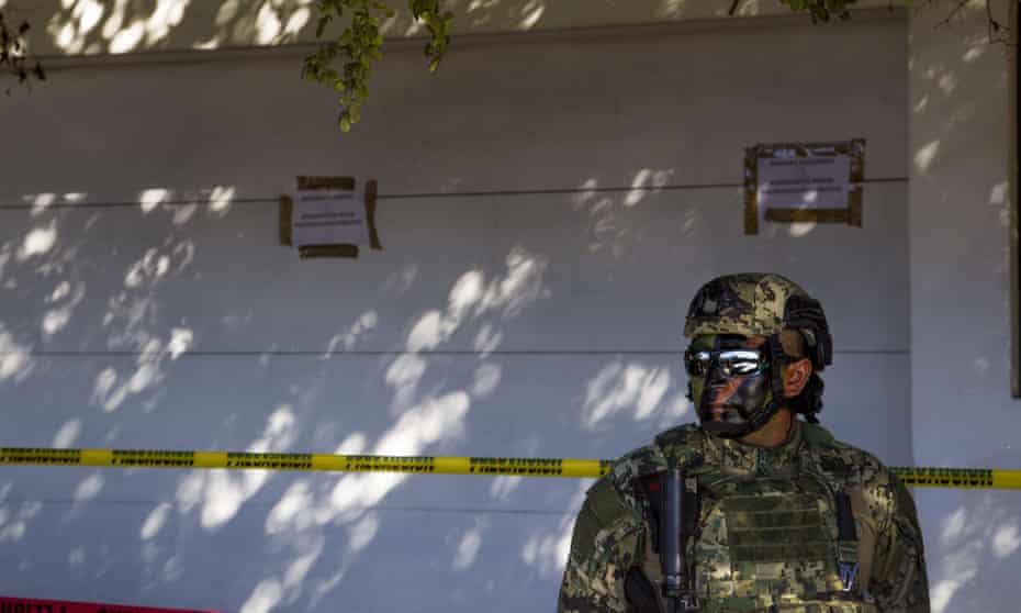 A Mexican marine keeps watch after the military operation which resulted in the recapture of Joaquin ‘El Chapo’ Guzman, in Los Mochis city, Sinaloa state, Mexico.