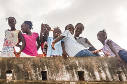 Young girls posing playfully in the streets of Freetown, Sierra Leone, Africa