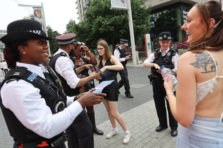 Officer Sherelle Jones hands a Dua Lipa fan a leaflet about the new initiative