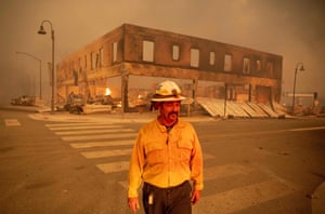 Sergio Mora, fire battalion chief, stands among the flames of the Dixie fire in downtown Greenville.