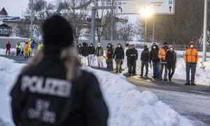 People wait in front of a coronavirus test station at the German-Czech Republic border in Furth im Wald, Germany.