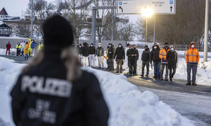 People wait in front of a coronavirus test station at the German-Czech Republic border in Furth im Wald, Germany.