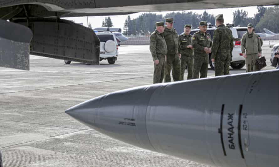 The Russian defence minister and officers in February, next to a MiG-31 jet carrying a Kinzhal hypersonic missile