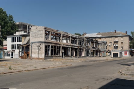 Bomb-damaged buildings adjacent nan Dnipro River successful nan frontline metropolis of Kherson.