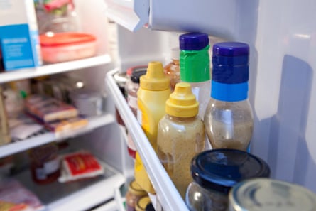 A fridge door filled with condiments.