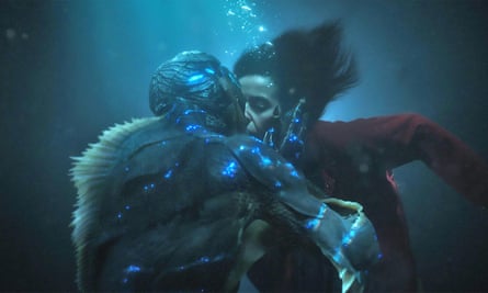 Sally Hawkins under water, kissing an amphibious creature. Film still from The Shape of Water.