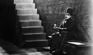 FILE - 100 Years Since Charlie Chaplin's Film Debut Lonely Tramp<br>FILE FEBRUARY 2, 2014: Charlie Chaplin debuted in his first film role in Keystone Studios Making a Living, which premiered one hundred years ago on February 2, 2014. Chaplin, who later went on to fame as The Little Tramp, played con man Edgar English in the film with the Keystone Kops. Chaplin debuted The Little Tramp character on February 7th, 1914. 1931: Comic actor Charlie Chaplin (1889 - 1977) sitting forlornly at the bottom of the steps in a scene from the film 'City Lights'. (Photo via John Kobal Foundation/Getty Images)