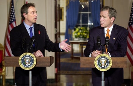Tony Blair and George W Bush stand at lecterns