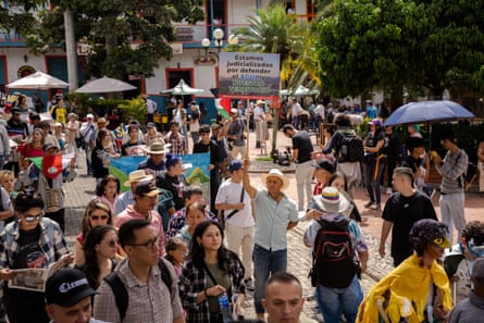 A group of protesters walk down a street.