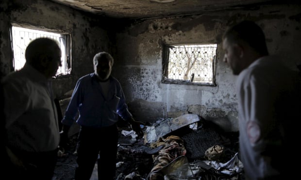 Palestinians inspect a house set on fire in a suspected attack by Jewish extremists yesterday.