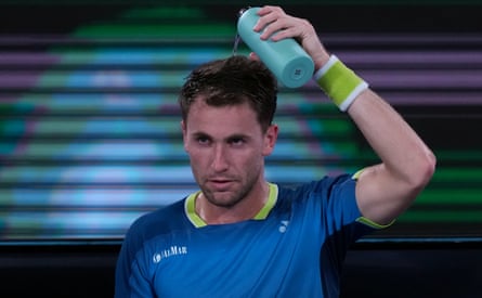 Casper Ruud pours water over his head during his third round match against Marin Cilic at the Australian Open.