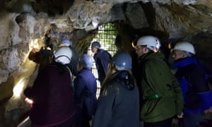 Members of the Subterranea Britannica group check out the witches’ marks at Creswell Crags.