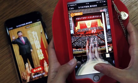 A woman plays a Tencent smartphone game called A Great Speech, Clap for Xi Jinping in Beijing in 2017.