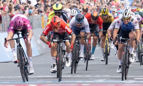 Arnaud Demare (left) nudges ahead of secon- placed Australian rider Caleb Ewan (centre) as Mark Cavendish (right) grimace in frustration