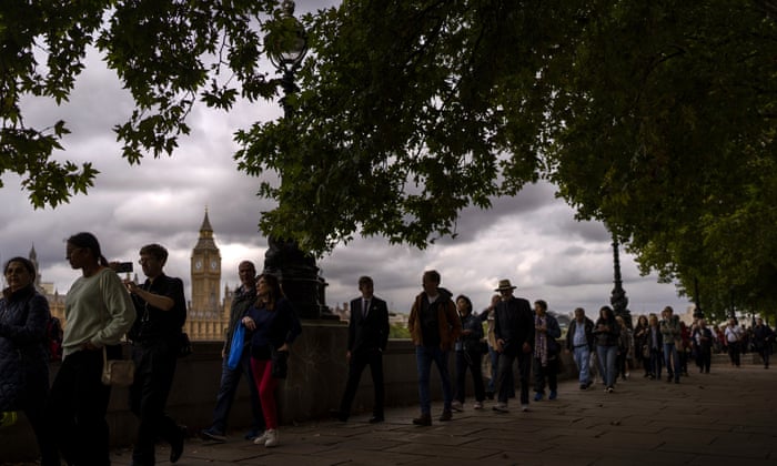 FILE - People line up to honor the late Queen Elizabeth II as she lies in state outside Westminster Hall in London, September 15, 2022. (AP Photo/Emilio Morenatti, File)