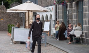 Residents walk in central in Aberdeen, eastern Scotland on August 5, 2020 following the announcement that a local lockdown has been imposed on the city after a spike in the number of cases of Covid-19. Credit: Michal Wachucik/AFP via Getty Images)