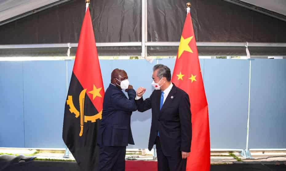 Angola’s foreign minister, Tete António, bumps elbows with his Chinese counterpart, Wang Yi, at a China-Africa conference in Dakar, Senegal, last month.