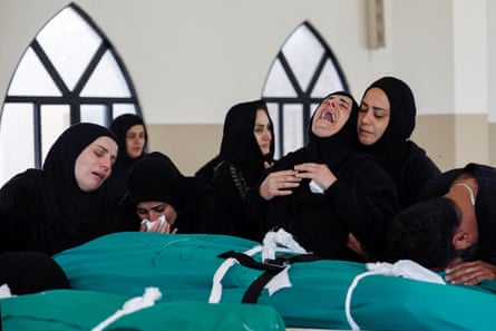 Relatives mourn over the bodies of four members of the Saeed family, including a 18-month-old girl, killed in an Israeli strike on Srifa.