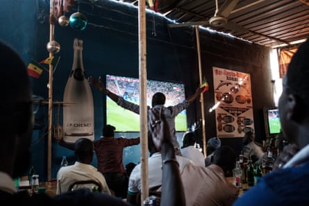 A Senegalese football fan celebrates during a world cup match at a local sports bar in Dakar.