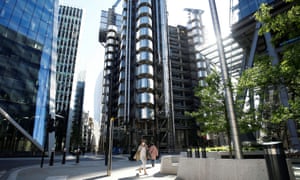 Lloyd's of London expects up to £3.5bn in coronavirus payouts 1 A woman wearing a protective face mask passes Lloyd’s building in London.
