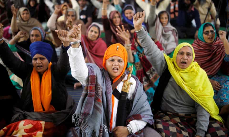 Women shout protest slogans at the Singhu camp.