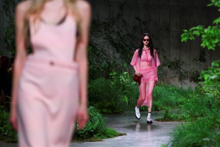 Models wearing long pink outfits